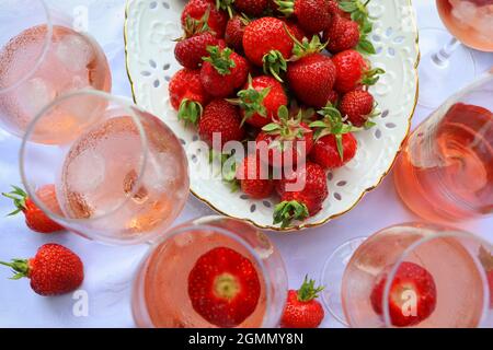 Creative composition with rose wine and delicious strawberries on the white background, top view Stock Photo