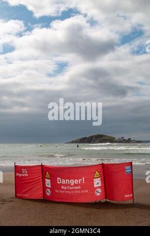 A RNLI banner warns swimmers of a rip current in the sea at Bantham Beach, Devon. Stock Photo