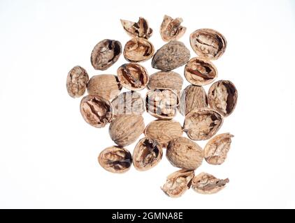 Top view of several nuts or parts of nut shells. open, unopened, with the edible part. Grouped and distributed on white background. Food concept, nuts Stock Photo
