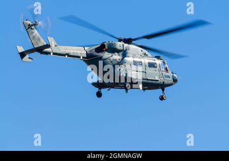 Dhruv, an advanced light helicopter developed by Hindustan Aeronautics Limited's, flies against the backdrop of a clear blue sky. Stock Photo