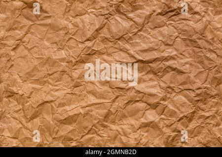 Ragged crumpled brown kraft paper seamless texture and full frame flat background. Stock Photo