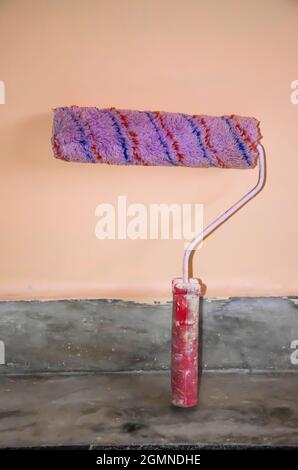 Selective focus on PIANT ROLLER BRUSH on marble isolated with pink background. Used for easy paint. Stock Photo