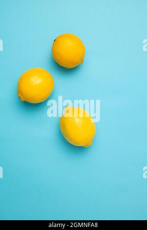 Ripe yellow lemons isolated on blue background with copy space for your text. Top view. Flat lay pattern, banner. Frame made of fresh lemons Stock Photo