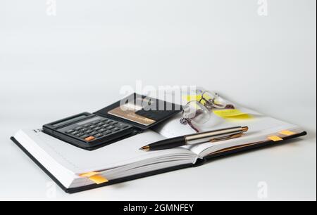 Diary, glasses, calculator, credit card and pen on a white background. Business concept Stock Photo
