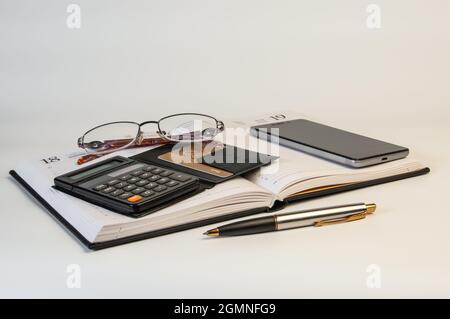 Diary, glasses, calculator, credit card, smartphone and pen on a white background. Business concept Stock Photo