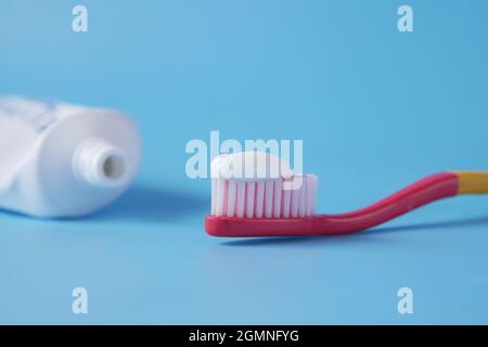 tooth brush with paste on blue background  Stock Photo