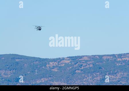 Dhruv, an advanced light helicopter developed by Hindustan Aeronautics Limited's, flies against the backdrop of a clear blue sky. Stock Photo