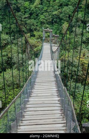 Suspension bridges leading to the viewpoint on Pailon del Diablo (Devil's Cauldron) waterfall near Banos town, Ecuador Stock Photo