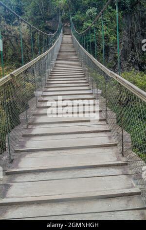 Suspension bridges leading to the viewpoint on Pailon del Diablo (Devil's Cauldron) waterfall near Banos town, Ecuador Stock Photo