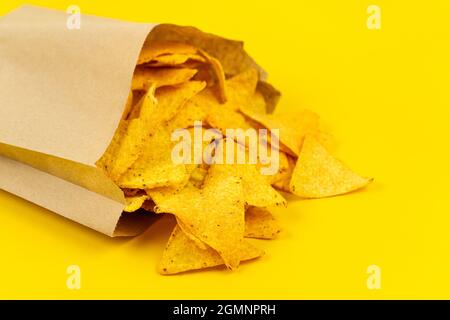 Crispy nachos chips in paper bag for convenience. Stock Photo