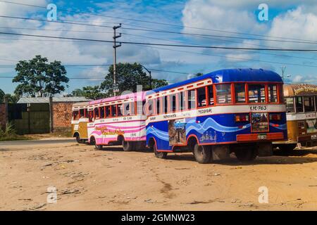 IQUITOS, PERU - JULY 19, 2015: Wooden buses stay on a bus terminal in Iquitos, Peru Stock Photo