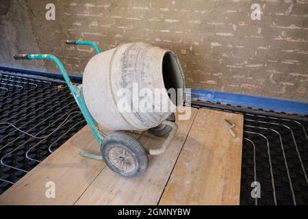 Concrete mixer on a radiant floor ready to be used. Stock Photo