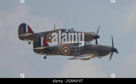 IWM Duxford, Cambridgeshire, UK. 18 September 2021. Flying display begins at The Battle of Britain Air Show on the former RAF site that played a central role as a base for many Spitfire and Hurricane pilots during the Second World War, with, appropriately, a flight of Hurricanes. Credit: Malcolm Park/Alamy Stock Photo