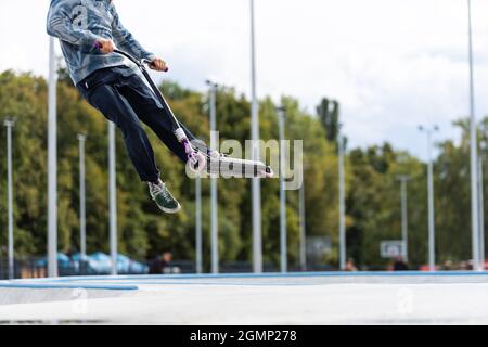 child going airborne with his scooter Stock Photo