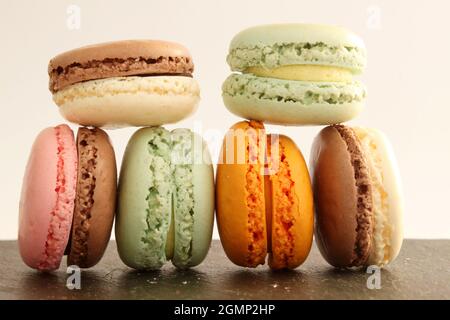 Different multicolor macarons on black stone plate Stock Photo
