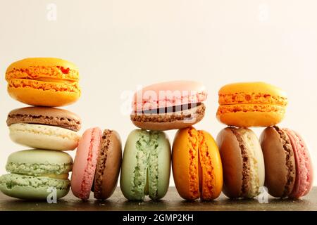 Different multicolor macarons on black stone plate Stock Photo