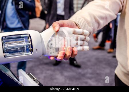 Human hand and robot's as a symbol of connection between people and artificial intelligence technology. Stock Photo