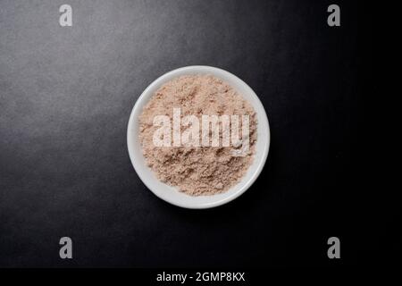 Top View of Rock Salt in Bowl On Dark Background Stock Photo