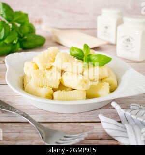 Homemade gnocchi with cheese and basil. Stock Photo