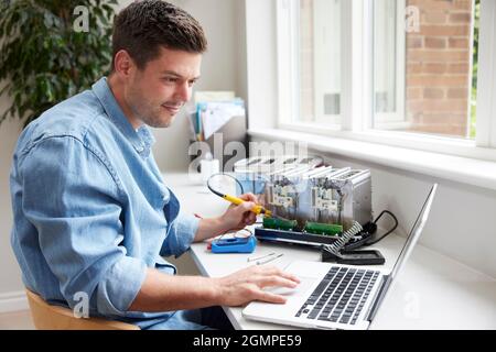 Man Fixing Electric Toaster Using Online Instructions Rather Than Buying New Product Sustainable Lifestyle Stock Photo