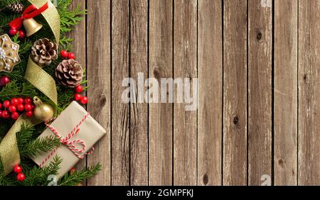 Christmas border composition made of fir branches, cones and gift box Stock Photo