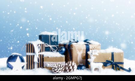 Christmas gift boxes covered by snow. Stock Photo