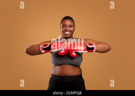 Strong athletic young black woman doing kick on white Stock Photo by  Prostock-studio