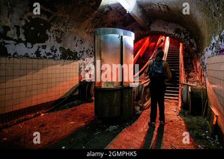 Dark and creepy old abandoned subway station. Broken escalator. Stock Photo