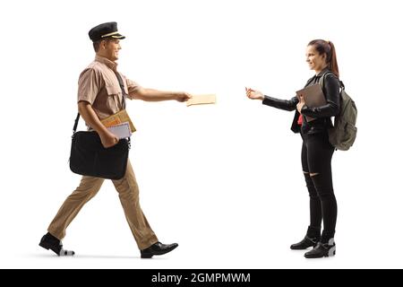 Full length profile shot of a mailman delivering letter to a female college student isolated on white background Stock Photo