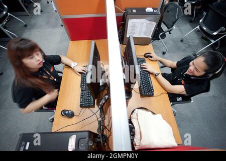 Customer Service Representatives at the Visaya Knowledge Process Outsourcing (VKPO) call center, in Makati, during the night shift. Stock Photo
