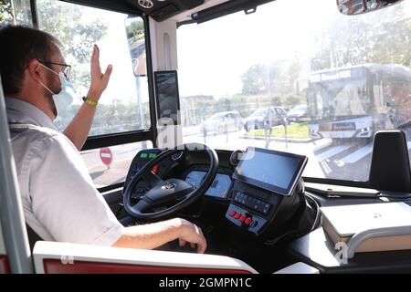 Paris, France. 17th Sep, 2021. A driver waves to another driver during the trial run of a self-driving bus made by China's CRRC Electric Vehicle, in Paris, France, Sept. 17, 2021. A 12-meter-long self-driving bus made by China's CRRC Electric Vehicle went on trial run on open road in Paris over the weekend. Credit: Gao Jing/Xinhua/Alamy Live News