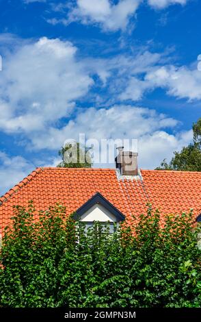 A suburban house in the Netherlands with blue sky and white clouds above Stock Photo