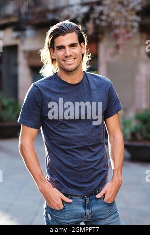 top model man using blue t-shirt and looking at camera for social media or dating apps Stock Photo