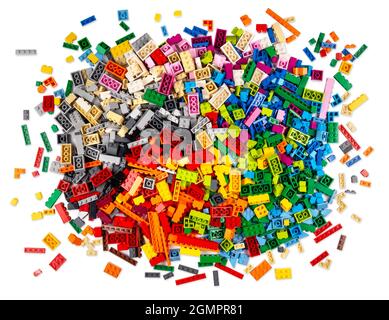 huge pile of stackable plastic toy bricks in top view isolated white background.  Colorful texture childhood education and development concept. Stock Photo