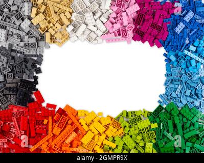 top view of frame of many various colorful rainbow colored stackable plastic toy bricks  with copy space isolated on white background Stock Photo