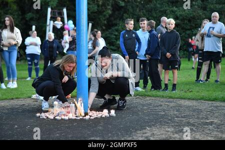 Members of the public light candles as they attend a vigil at the scene in Chandos Crescent, Killamarsh, near Sheffield, where four people were found dead at a house on Sunday. Picture date: Monday September 20, 2021. Stock Photo
