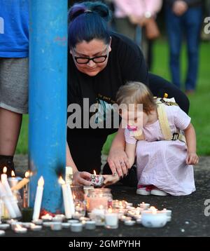 Members of the public light candles as they attend a vigil near to the scene in Chandos Crescent, Killamarsh, near Sheffield, where four people were found dead at a house on Sunday. Picture date: Monday September 20, 2021. Stock Photo
