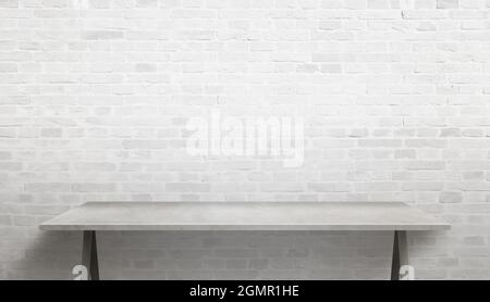 Empty work desk with brick wall in background Stock Photo