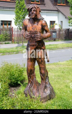 Cesky Tesin, Czech Republic - June 5, 2021: Wooden sculpture with flute. Stock Photo