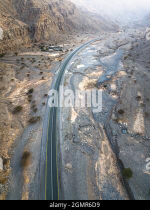 Aerial view of Jebel Jais mountain desert highway road surrounded by sandstones in Ras al Khaimah emirate of the United Arab Emirates Stock Photo