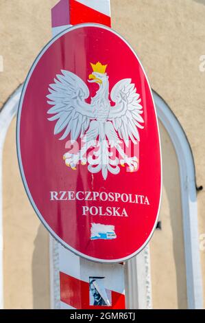 Cieszyn, Poland - June 5, 2021: Coat of arms of Poland, white, crowned eagle with a golden beak and talons, on a red background. Stock Photo
