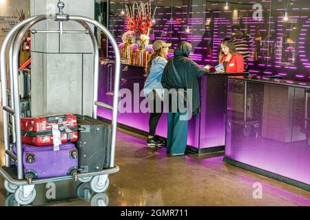 London England,UK,South Bank,Park Plaza Waterloo hotel,front desk reception lobby check-in,inside interior luggage cart woman female guest Muslim Stock Photo