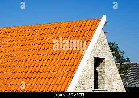 restoration of a historic brick house, chimney repair and replacement of roof clay tiles Stock Photo