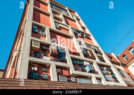 A lot of different mailboxes on the wall of the building outside Stock Photo