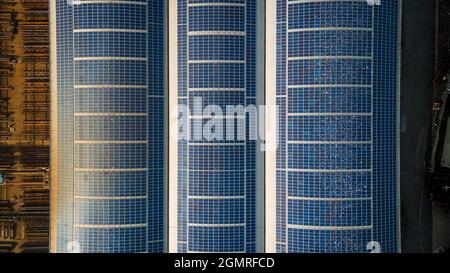 Aerial view of solar panels on warehouse top roof in industrial estate, Hove, East Sussex, UK. Stock Photo