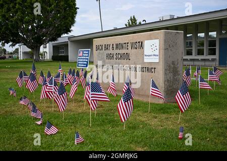 Small American flags are places around signage at Back Bay and Monte Vista High School, Tuesday, Aug. 31, 2021, in Costa Mesa, Calif. The flags were p Stock Photo