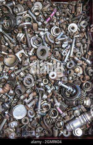 Box of random nuts and bolt, parts, washers, screws in workshop garage. Stock Photo