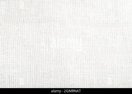 Fragment of smooth white linen tissue. Top view, flat lay, natural textile background and texture. Stock Photo