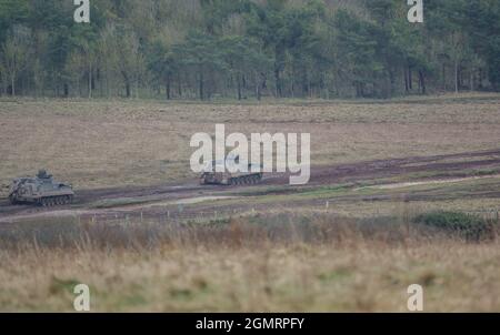 British army Warrior FV512 MRV & Warrior FV510 IFV tanks in action on a military exercise, Salisbury Plain, Wilts UK Stock Photo