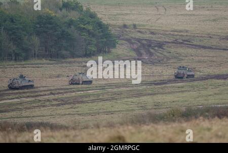 British army Warrior FV512 MRV & Warrior FV510 IFV tanks in action on a military exercise, Salisbury Plain, Wilts UK Stock Photo